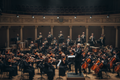Symphony orchestra performing with COVID masks - Prayer, Pain, Panic and Poise